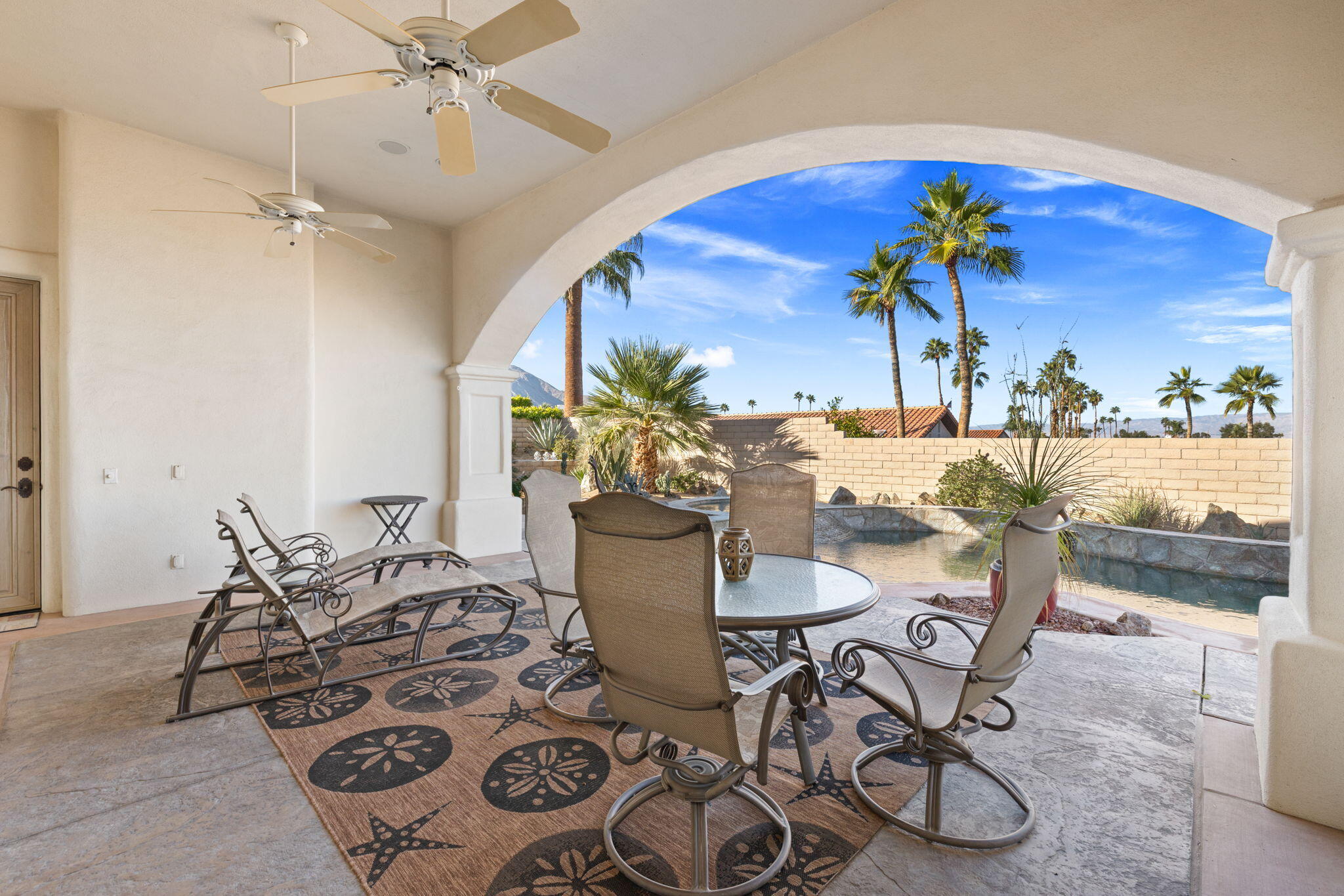 73110 Calliandra Street Palm Desert, CA 92260 - Photo 45 of 67 a view of a dining room with furniture and a potted plant
