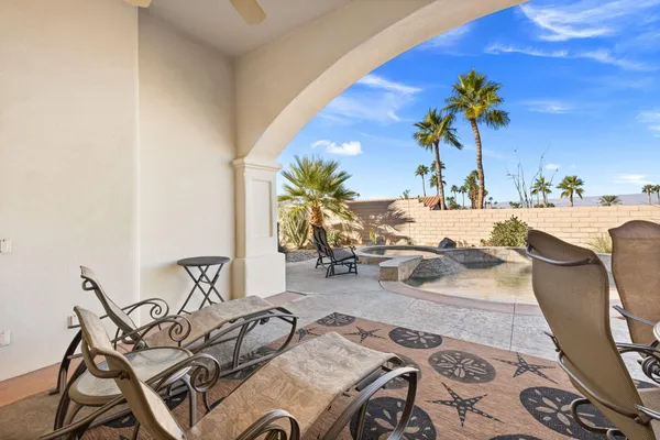 a view of a patio with dining table and chairs with plants