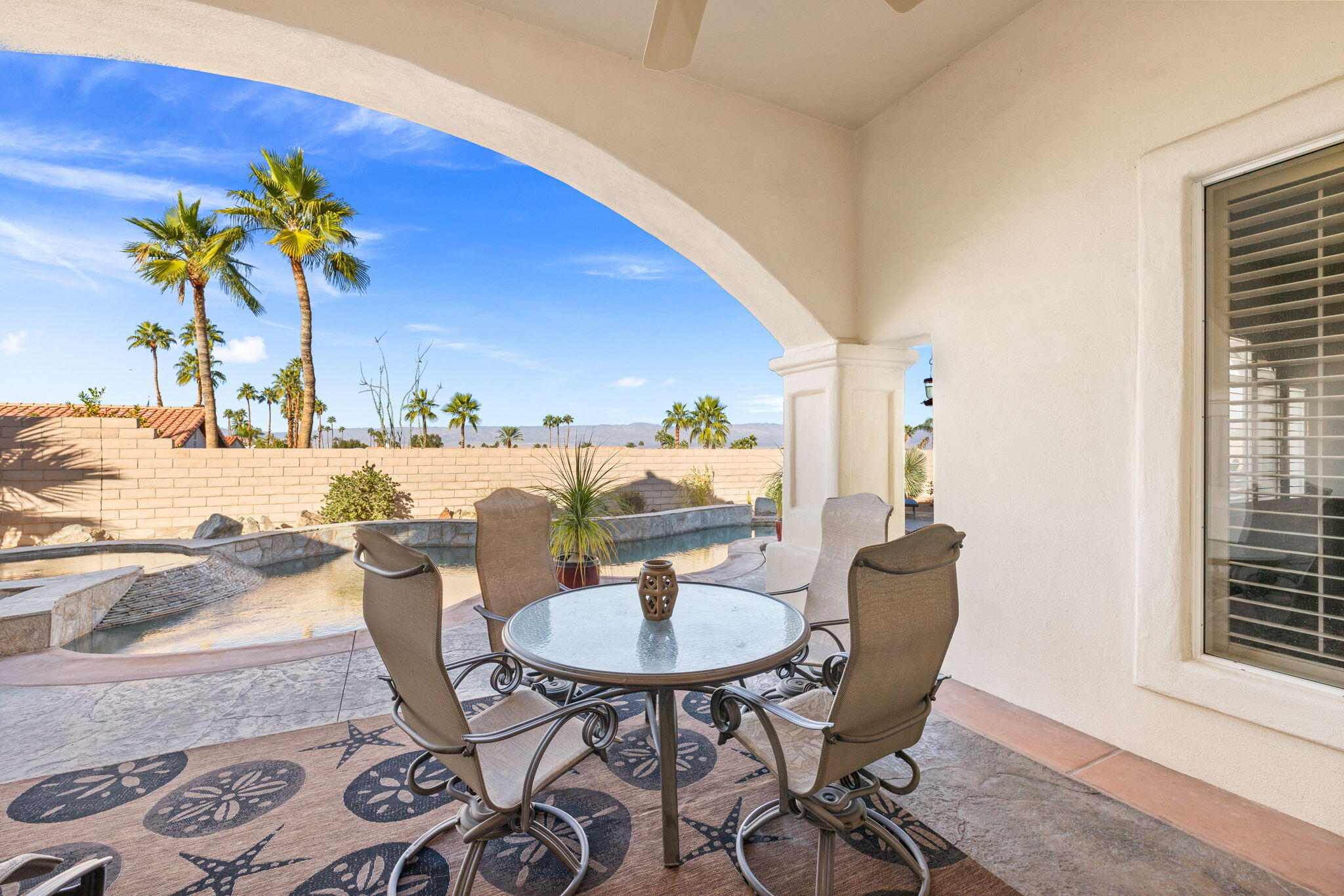 73110 Calliandra Street Palm Desert, CA 92260 - Photo 47 of 67 a dining room with furniture and a potted plant