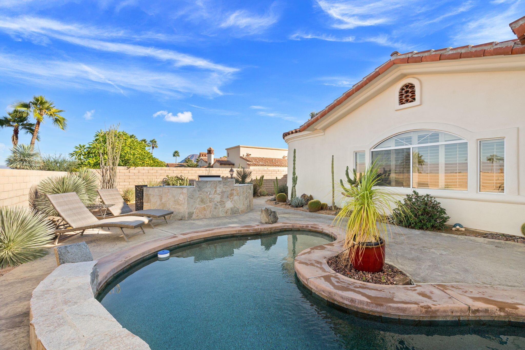 73110 Calliandra Street Palm Desert, CA 92260 - Photo 55 of 67 a swimming pool with outdoor seating and plants