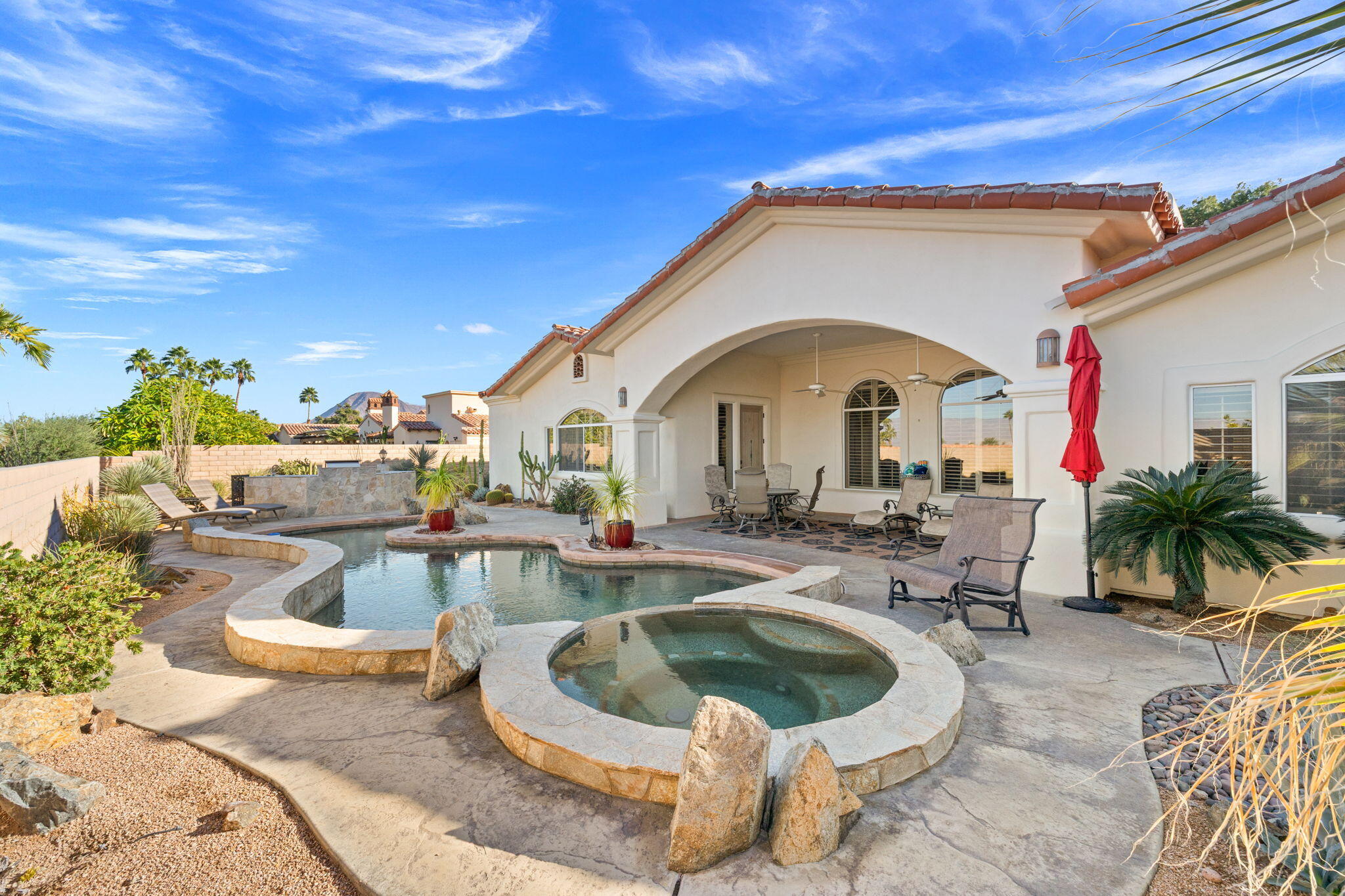 73110 Calliandra Street Palm Desert, CA 92260 - Photo 56 of 67 a view of a patio with dining table and chairs with plants
