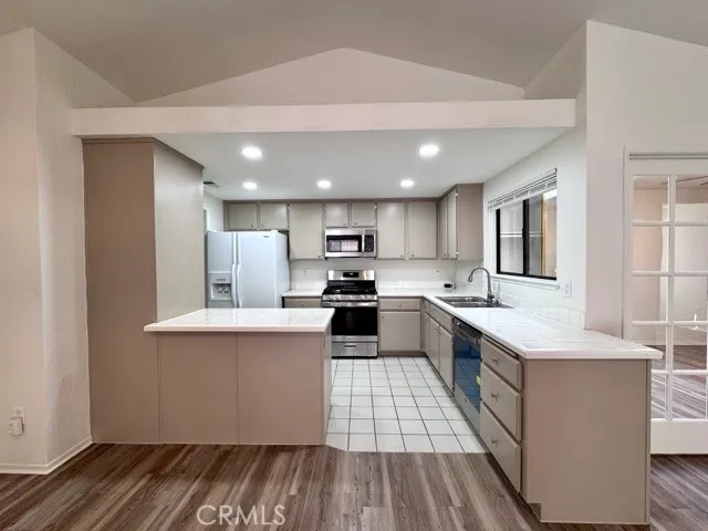 a kitchen with a sink stainless steel appliances and cabinets