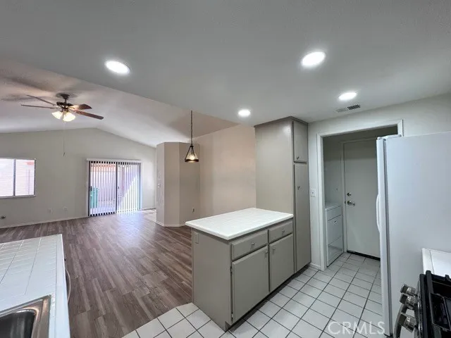 a bathroom with a granite countertop sink a toilet and mirror