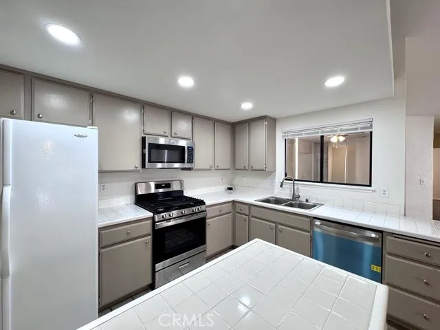 a kitchen with a sink a stove and refrigerator