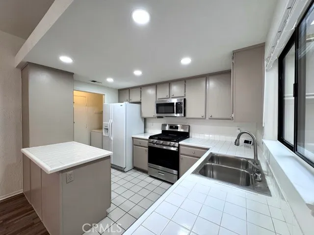 a kitchen with stainless steel appliances granite countertop a sink counter space cabinets and a sink