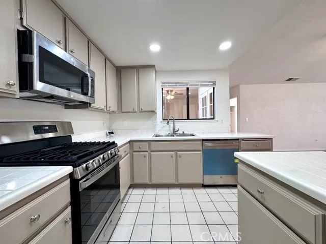 a kitchen with a sink stove and microwave