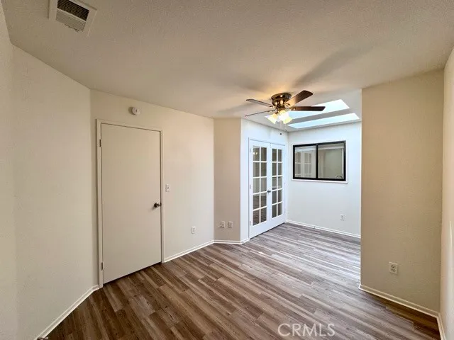 a view of a livingroom with wooden floor and a ceiling fan