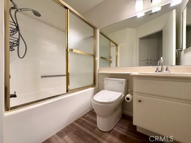 a bathroom with a toilet sink and shower
