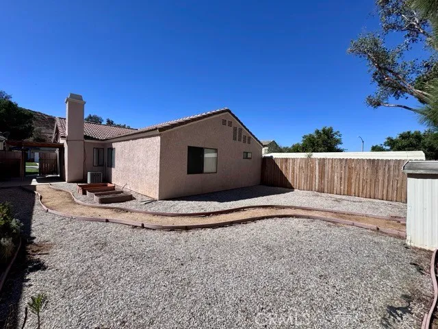 a view of a house with wooden fence