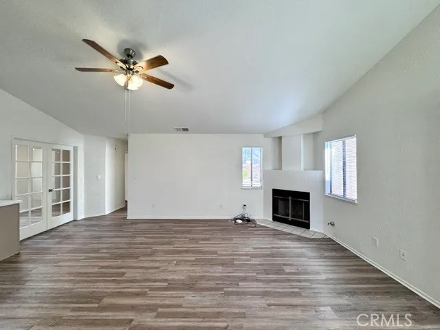 a view of empty room with wooden floor fireplace and windows