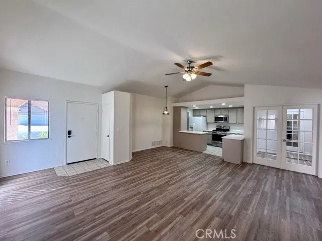 a view of a kitchen with wooden floor and a kitchen space