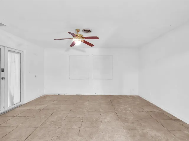 a view of an empty room and a window