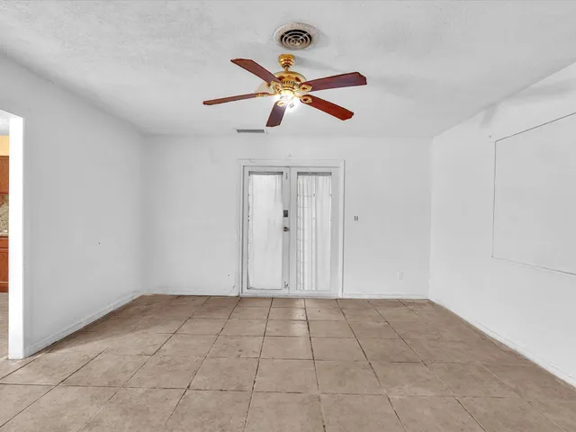 a spacious bathroom with a double vanity sink toilet mirror and bathtub