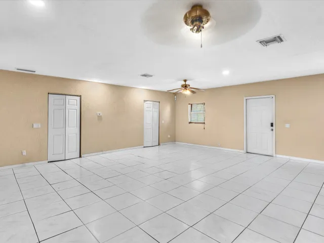 a front view of house with yard and ocean