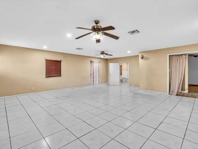 an aerial view of a house with a yard and lake view