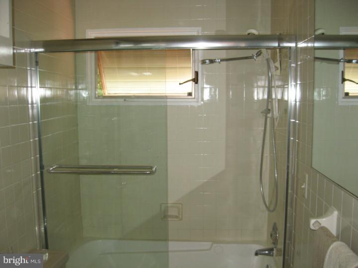 10 Round Hill Road Voorhees, NJ 08043 - Photo 22 of 25 a bathroom with a glass shower door