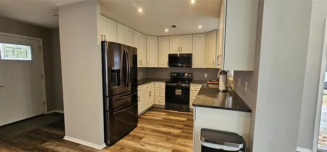 a kitchen with a refrigerator stove and microwave