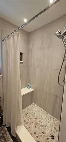 a bathroom with a shower curtain and a sink