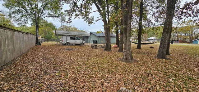 a view of a house with trees in the background