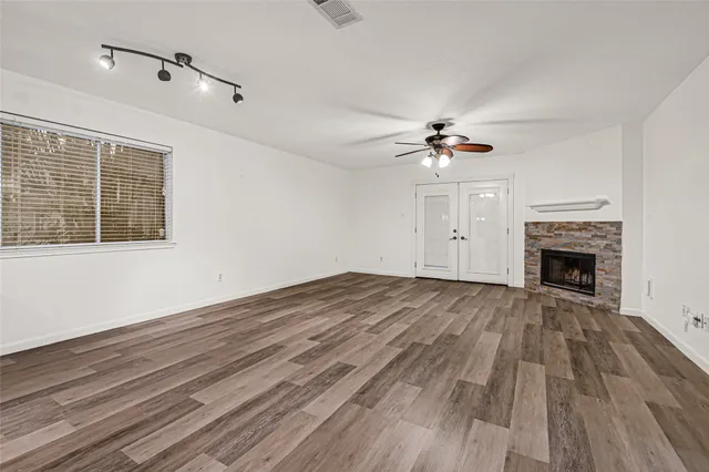 wooden floor in an empty room with a fireplace