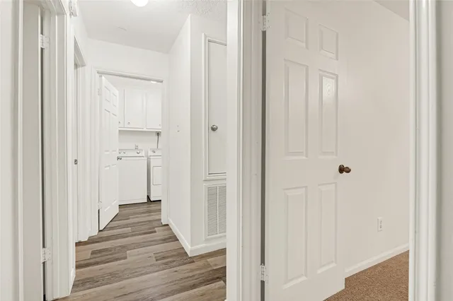 a view of a hallway with a wooden door