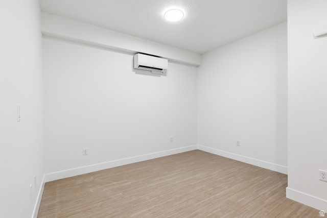 2085 North Main Street, Unit 409 Sunset, UT 84015 - Photo 4 of 17 Living room with light wood-style flooring and a wall mounted mini split