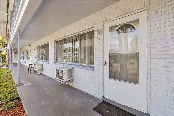 a hallway with a bench and windows