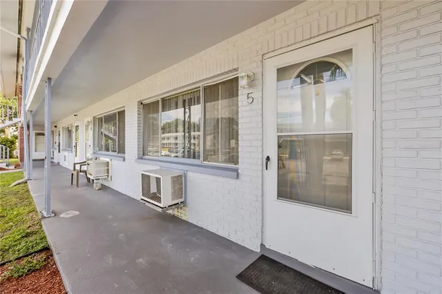 a hallway with a bench and windows