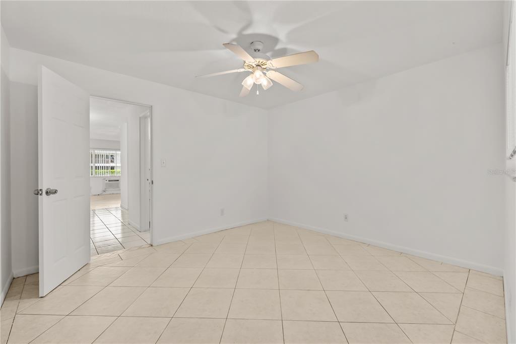 2353 Shelley Street, Unit 5 Clearwater, FL 33765 - Photo 16 of 21 an empty room with white walls and ceiling fan