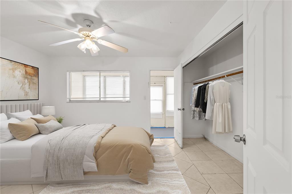 2353 Shelley Street, Unit 5 Clearwater, FL 33765 - Photo 4 of 21 a bedroom with a bed and a chandelier