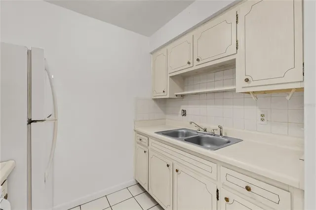a kitchen with white cabinets and a sink
