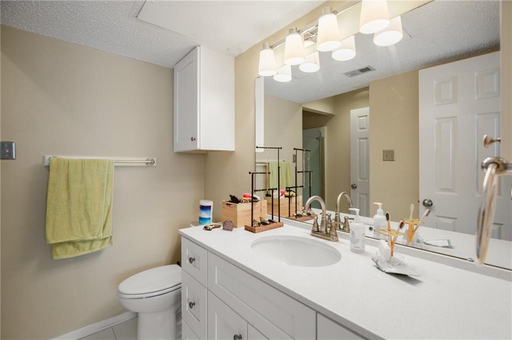 806 West 24th Street, Unit 228 Austin, TX 78705 - Photo 6 of 6 a bathroom with a sink a toilet and mirror