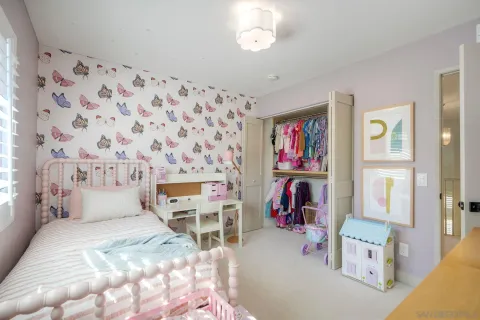 a bedroom with furniture and a flat screen tv