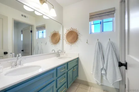 a bathroom with a sink vanity and a mirror