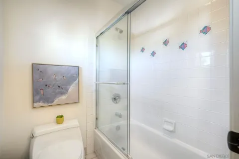a bathroom with a shower and a toilet