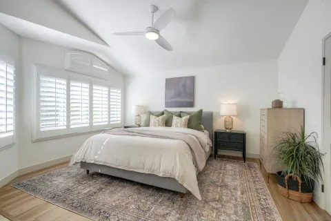 a bedroom with bed and a potted plant