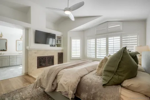 a spacious bedroom with a bed and a fireplace