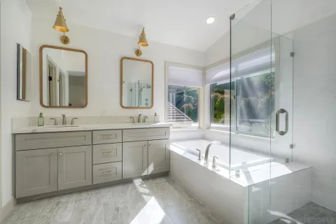 a large spacious bathroom with a tub sink and mirror