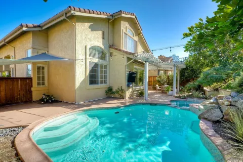 a view of a house with backyard porch and sitting area