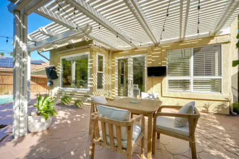 a view of a patio with table and chairs and potted plants