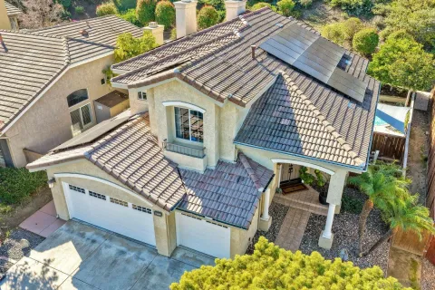 an aerial view of a house with a yard and garden