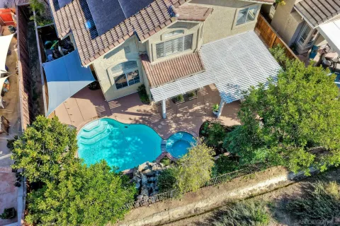 aerial view of a house with pool and garden
