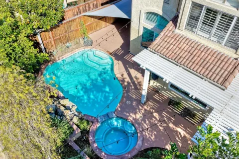 an aerial view of a house with a yard and lake view