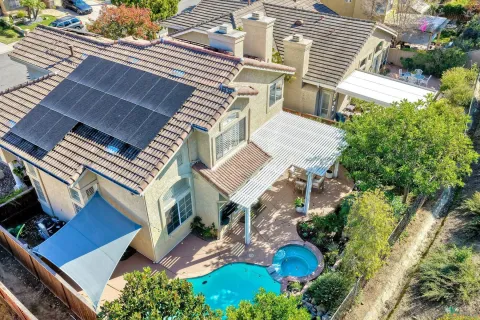 an aerial view of a house with a yard and garden