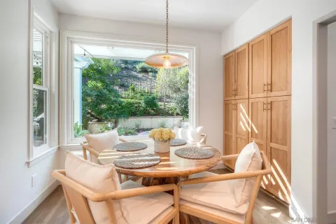 a dining room with furniture a chandelier and wooden floor