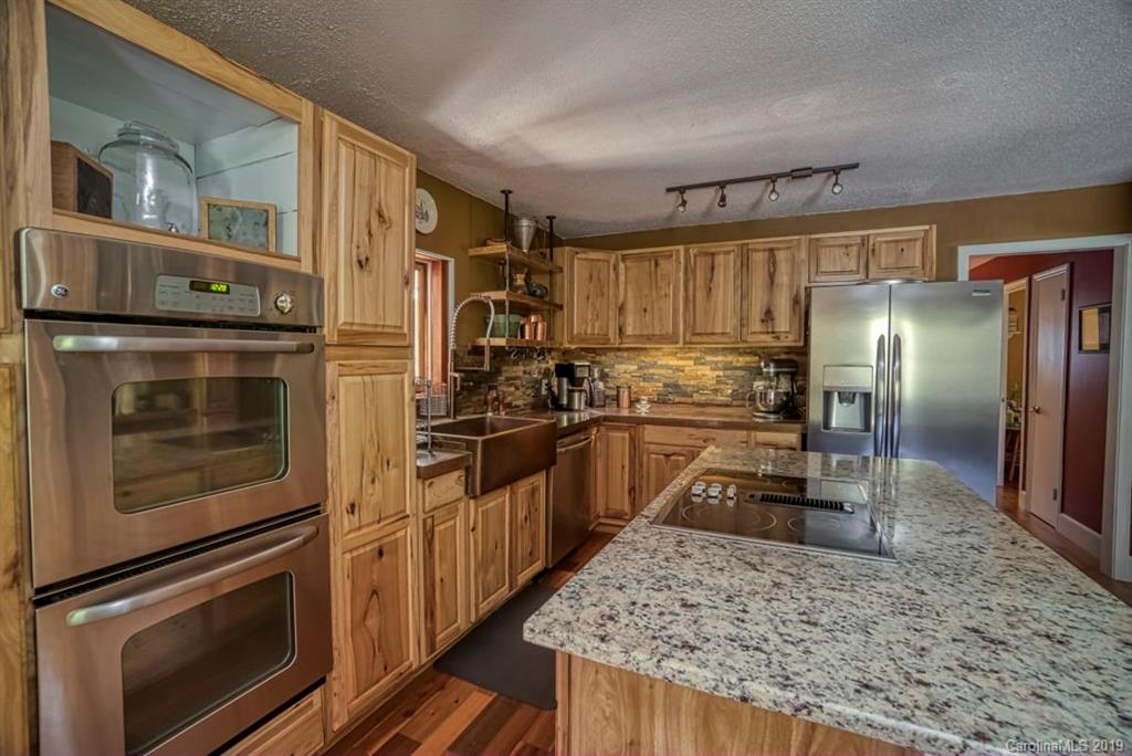 18100 Barnhardt Road Davidson, NC 28036 - Photo 11 of 29 a kitchen with granite countertop a refrigerator stove and oven