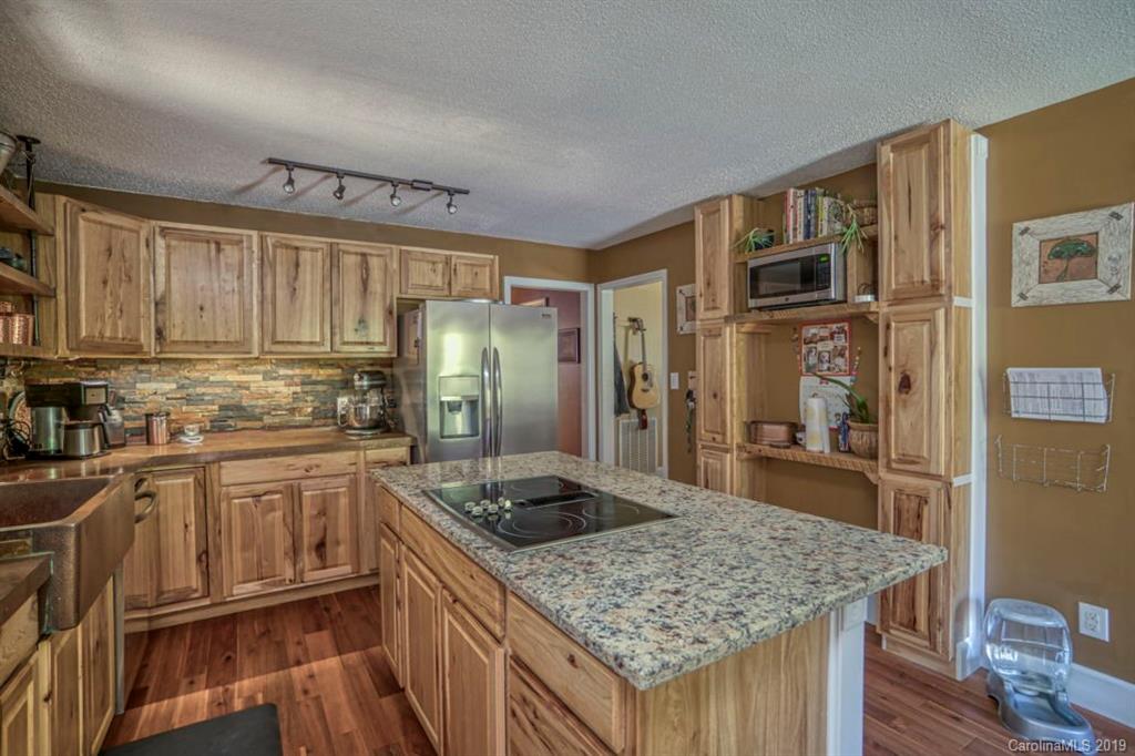 18100 Barnhardt Road Davidson, NC 28036 - Photo 12 of 29 a kitchen with stainless steel appliances granite countertop a sink stove and refrigerator