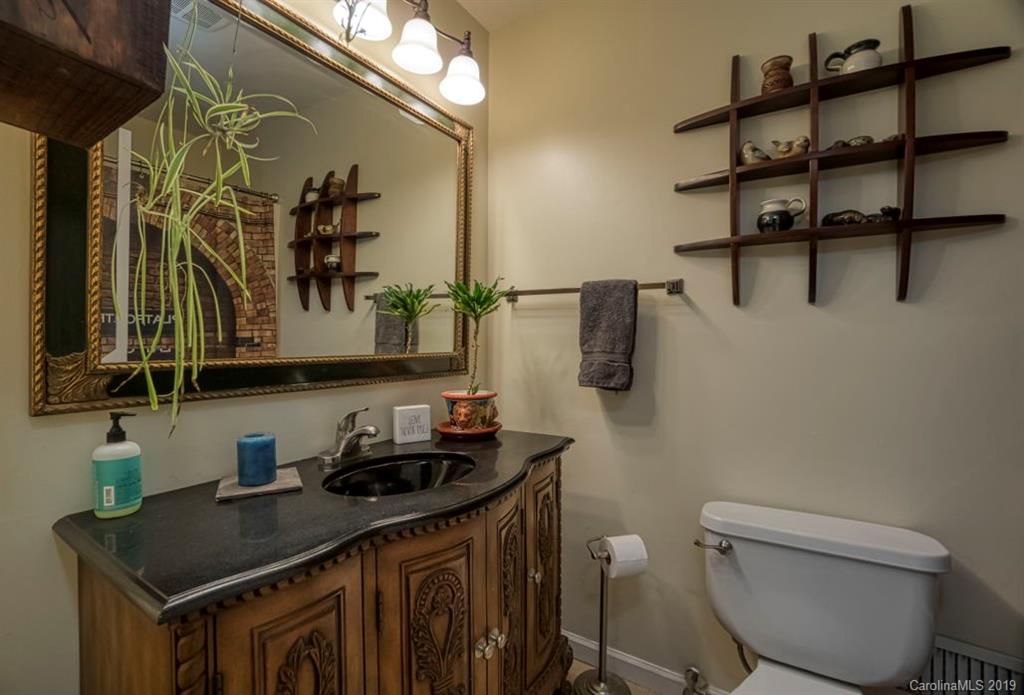 18100 Barnhardt Road Davidson, NC 28036 - Photo 13 of 29 a bathroom with a granite countertop sink a toilet and a mirror