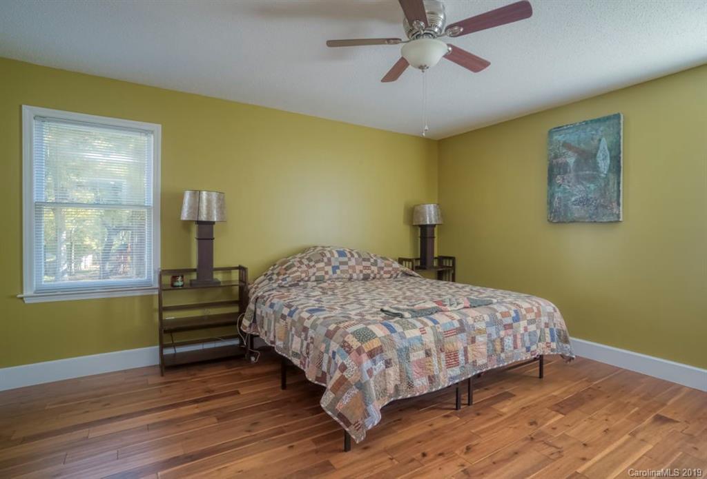 18100 Barnhardt Road Davidson, NC 28036 - Photo 15 of 29 a bedroom with a bed wooden floor and window