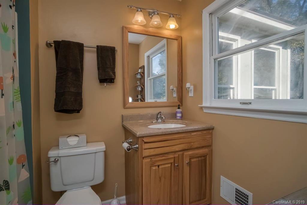 18100 Barnhardt Road Davidson, NC 28036 - Photo 16 of 29 a bathroom with a toilet sink and mirror